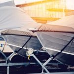 Row of boats in storage for the winter under the awning. Warehouse on the boat pier. Concept preparation for winter.