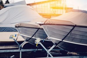 Row of boats in storage for the winter under the awning. Warehouse on the boat pier. Concept preparation for winter.